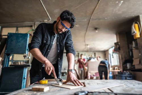 mid adult carpenter carving wood with chisel and hammer at carpentry - home decoration stock pictures, royalty-free photos & images