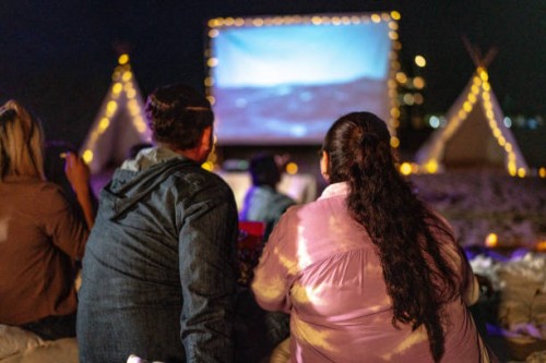 mid adult couple watching a movie at the outdoors cinema - concert stock pictures, royalty-free photos & images
