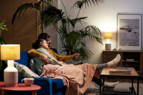 mid adult couple watching tv in living room - home decoration stock pictures, royalty-free photos & images
