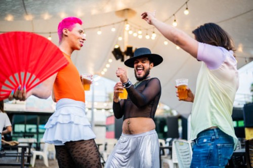 mid adult friends dancing on a gay festival - concert stock pictures, royalty-free photos & images