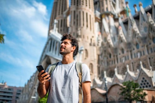mid adult male tourist with smart phone in barcelona - travel stock pictures, royalty-free photos & images