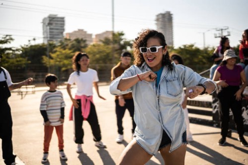 mid adult woman dancing reggaeton during street party outdoors - concert stock pictures, royalty-free photos & images