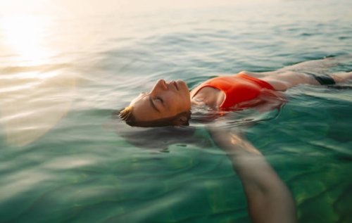 mid adult woman swimming in the calm sea water - travel stock pictures, royalty-free photos & images