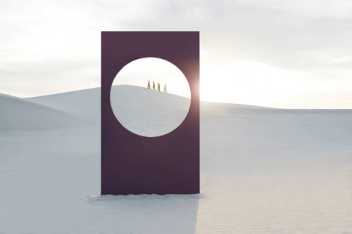 mid distance view of female models walking at white desert seen through window frame - fashion stock-fotos und bilder