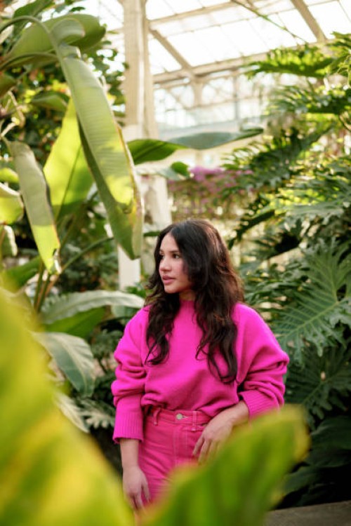 mid waist portrait of caucasian young woman with pink clothes in nature background - fashion stock pictures, royalty-free photos & images