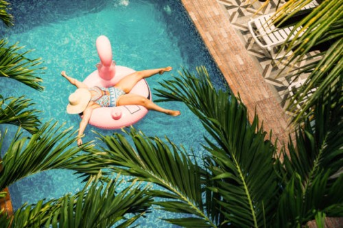 middle age woman swimming in the pool with inflatable swim ring - travel stock pictures, royalty-free photos & images