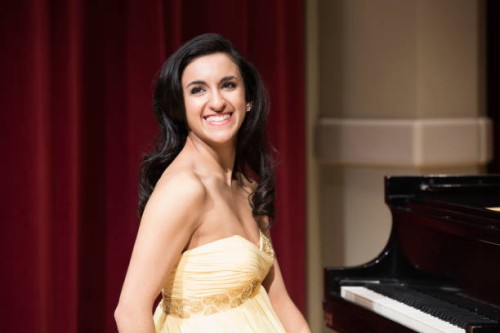 middle eastern woman smiling at piano - concert stock pictures, royalty-free photos & images