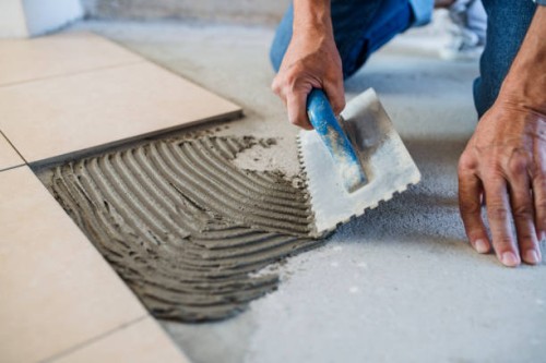 midsection of senior man laying tile floor in new home. - home decoration stock pictures, royalty-free photos & images