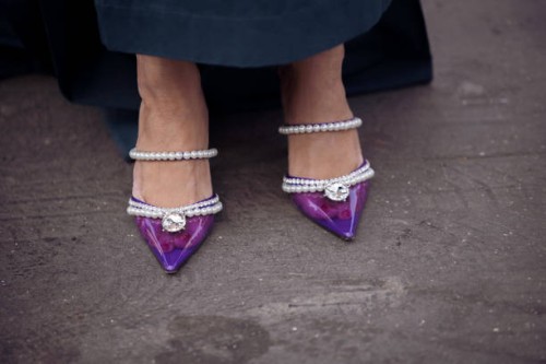 Miki Cheung seen wearing a pink Valentino belt and a matching pink bag by Valentino, Chanel shades and earrings by Chanel, a long skirt and purple...