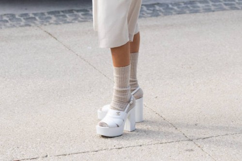 Millan Delaroiere wears Chanel shoes and shorts and camel wool socks outside the Chanel show during Womenswear Spring/Summer 2025 as part of Paris...