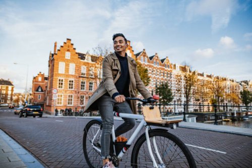 millennial asian tourist in the city with bicycle - travel stock pictures, royalty-free photos & images