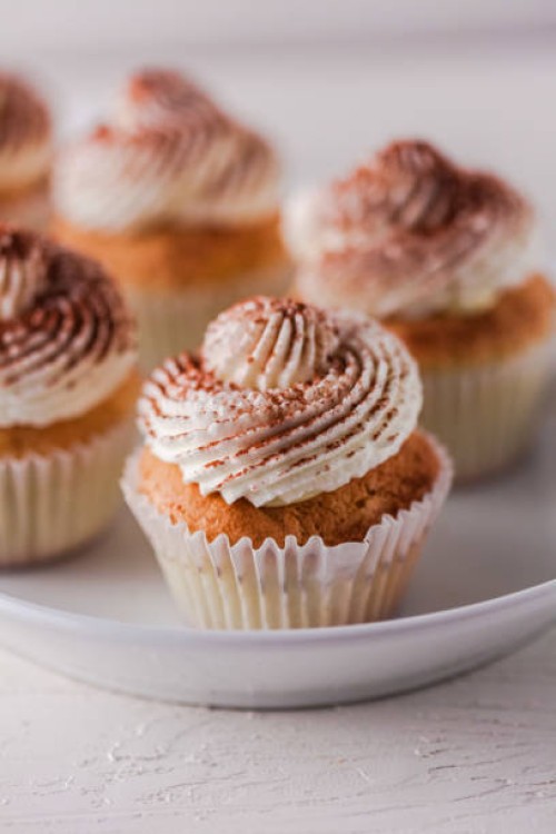 mini tiramisu cupcakes with cocoa dusting - junk food stock pictures, royalty-free photos & images