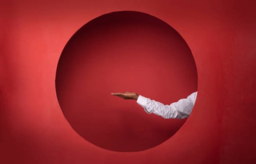 minimalistic studio setting in vivid red background - fashion stock-fotos und bilder