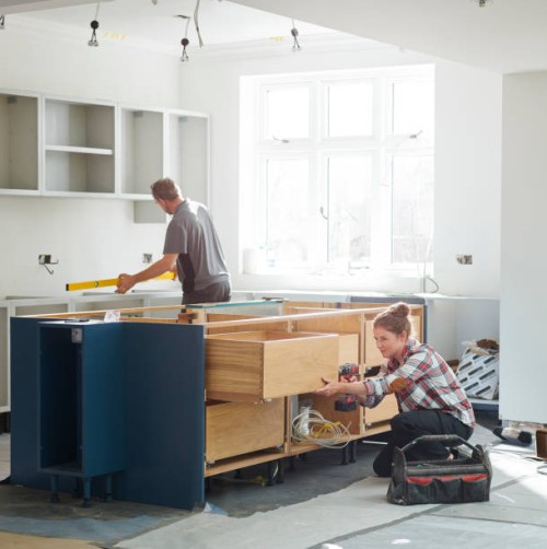 mixed gender kitchen fitters - home decoration stock pictures, royalty-free photos & images