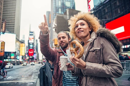 mixed race couple visiting times square new york in autumn. - food stock pictures, royalty-free photos & images