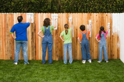 mixed race family painting fence - garden decoration stock pictures, royalty-free photos & images