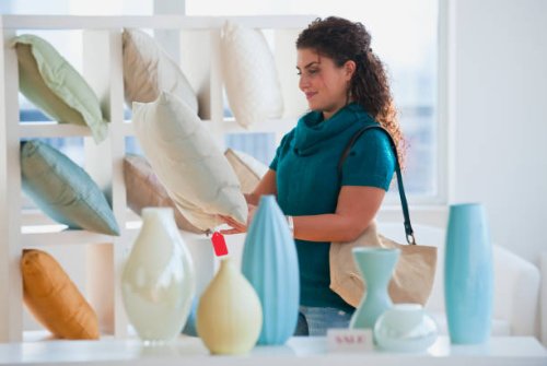 mixed race woman shopping for pillows - home decoration stock pictures, royalty-free photos & images