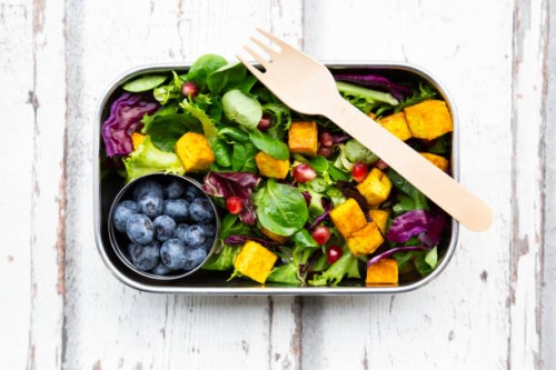 mixed salad with roasted tofu, red cabbage, pomegranate seeds, blueberries and curcuma in lunch box - junk food stock pictures, royalty-free photos & images
