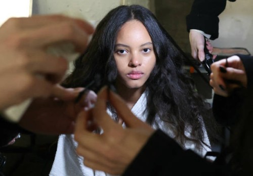 Model has her hair prepared backstage before presenting a creation by Vaquera for the Womenswear Ready-to-wear Fall-Winter 2025/2026 collection as...