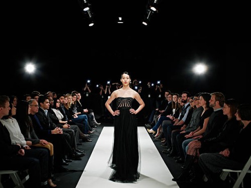 model in gown walking down catwalk - fashion stock pictures, royalty-free photos & images