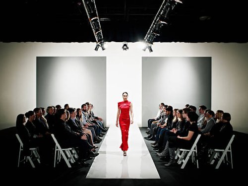 model in gown walking down catwalk at fashion show - fashion week stock pictures, royalty-free photos & images