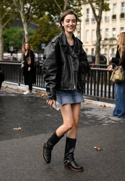 Model is seen wearing a black biker jacket, denim skirt and black boots outside the Chanel show during the Womenswear Spring/Summer 2024 as part of...