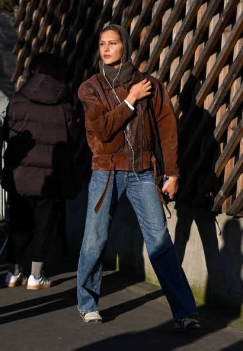 Model is seen wearing a brown jacket, blue jeans and headscarf outside the Stella McCartney show during the Womenswear Fall/Winter 2025/2026 as part...