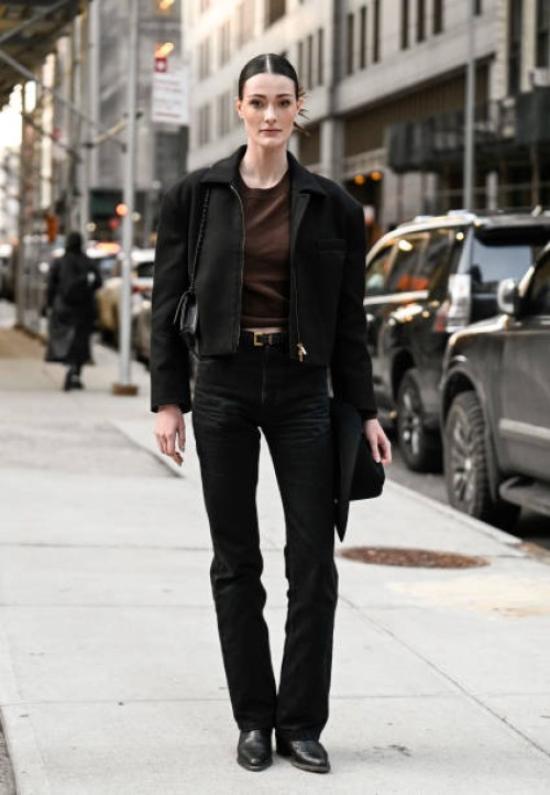 Model Jace Higgins is seen wearing a black jacket, brown t-shirt, black jeans and black bag with black hat and black shoes outside the Bronx and...