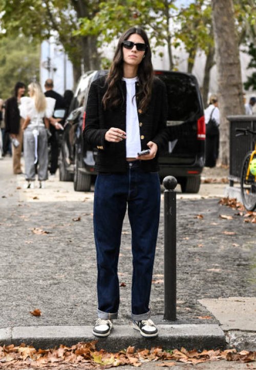Model Loli Bahia is seen wearing a black jacket, white t-shirt, blue jeans and black sunglasses outside the Chanel show during the Womenswear...
