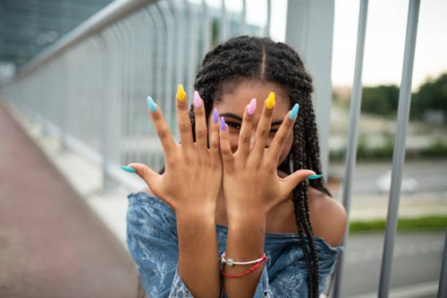 model on city bridge posing with colorful nails - fashion stock pictures, royalty-free photos & images