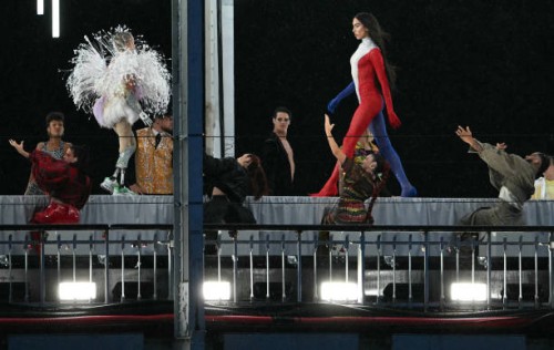 Model presents creations while walking a catwalk erected along the Passerelle Debilly bridge on the Seine river during the opening ceremony of the...