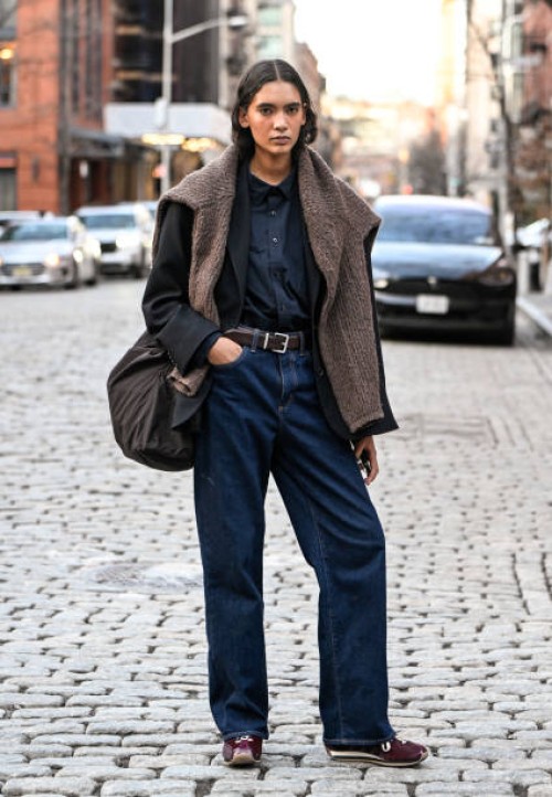 Model Summer Zoe Thompson is seen wearing a black jacket, black shirt, blue jeans, brown belt, brown shoes and brown sweater outside the Ashlyn show...