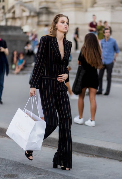 Model wearing a striped suit and shopping bag outside Alexandre Vauthier during Paris Fashion Week - Haute Couture Fall/Winter 2017-2018 : Day Three...
