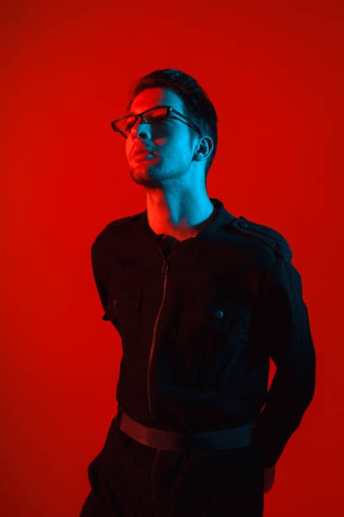 models hipster man with glasses on a red glowing background - fashion stock pictures, royalty-free photos & images