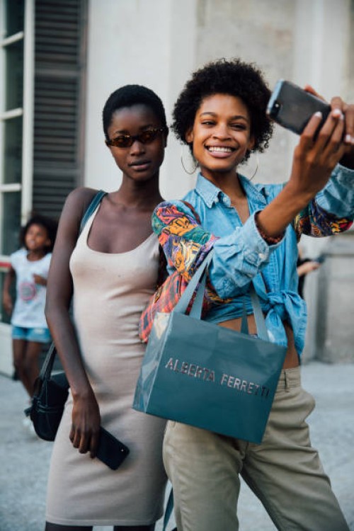 Models Oumie Jammeh, Theresa Hayes take a selfie outside the Alberta Ferretti Resort 2019 show during Milan Men's Fashion Week Spring/Summer 2019 on...