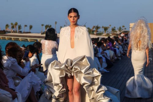 Models present creations of Saudi designer Tima Abid during a show at the Red Sea Fashion Week in Saudi Arabia's Ummahat Island on May 16, 2024.