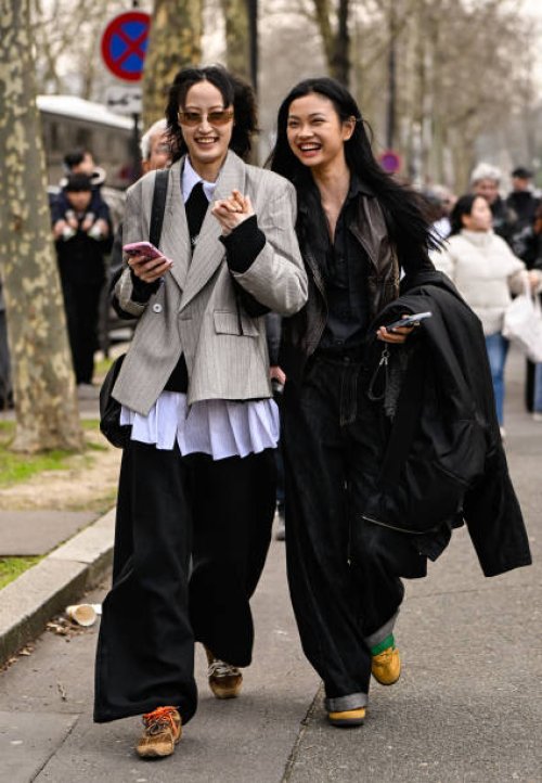 Models Xiaohan Chen and Yu Gue are seen wearing a gray jacket and brown jacket outside the Miu Miu show during the Womenswear Fall/Winter 2025/2026...