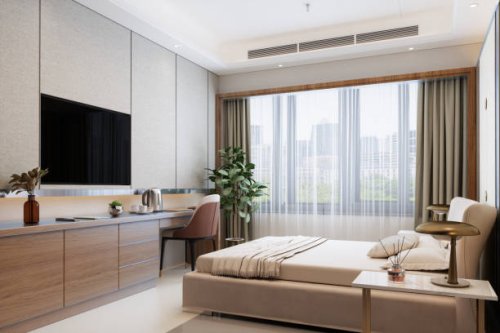 modern hotel room with double bed, night tables, tv set and cityscape from the window - home decoration stock pictures, royalty-free photos & images