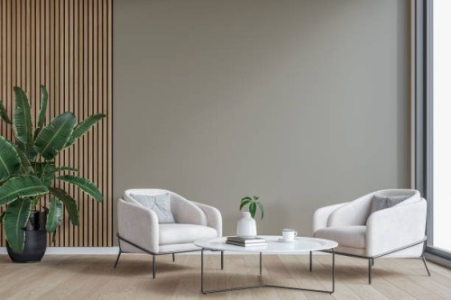 modern interior: a living/waiting room with a couple of cozy armchairs in front of a partly light gray, partly hardwood paneled accent wall background, large window and decoration - home decoration stock pictures, royalty-fre