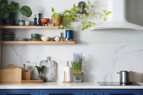 modern kitchen with blue facades, white hood, marble wall and open wooden shelves with potted plants - home decoration stock pictures, royalty-free photos & images