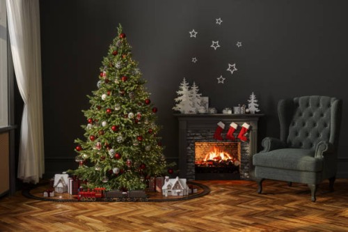 modern living room with christmas tree, miniature train, gift boxes, fireplace and armchair - home decoration stock pictures, royalty-free photos & images