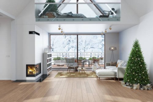 modern villa interior with christmas tree, gift boxes, fireplace, sofa and snowy garden view through the window. attic bedroom decorated for christmas - garden decoration stock pictures, royalty-free photos & images