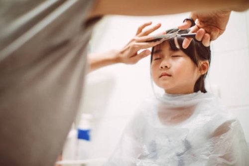 mom cutting lovely little daughter's hair - hairstyle stock pictures, royalty-free photos & images