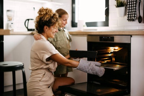 mother and daughter are baking bread - food stockfoto's en -beelden