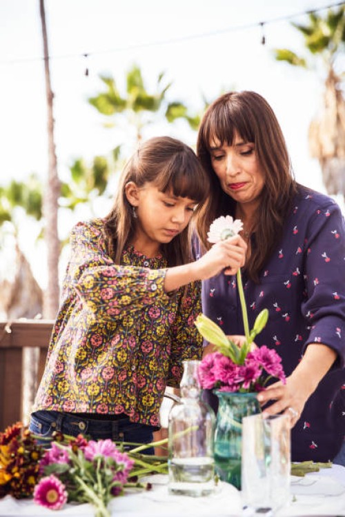mother and daughter arranging flowers in a vase - garden decoration stock pictures, royalty-free photos & images