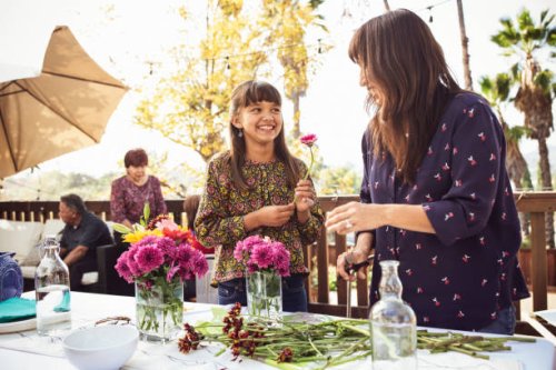 mother and daughter arranging flowers on table in backyard - garden decoration stock pictures, royalty-free photos & images