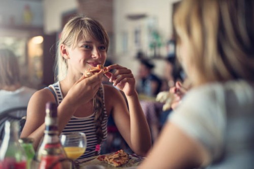 mother and daughter having pizza in piza restaurant - food stock pictures, royalty-free photos & images