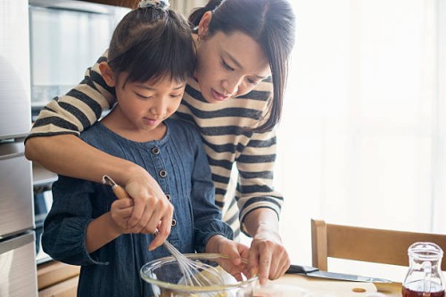 mother and daughter making cookies together - food stock pictures, royalty-free photos & images