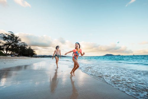 mother and daughter play on the beach - travel stock pictures, royalty-free photos & images