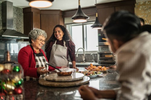 mother and daughter preparing food for family at kitchen at home - food stock pictures, royalty-free photos & images